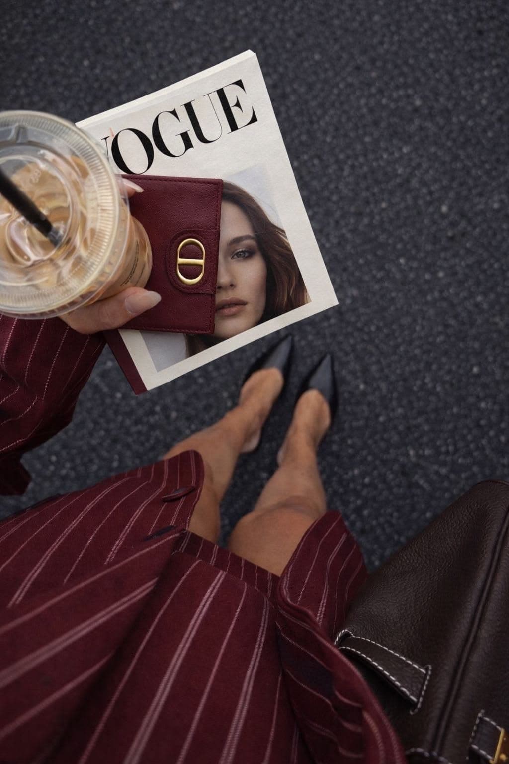 Burgundy leather wallet and pinstripe suit with black pointed heels
